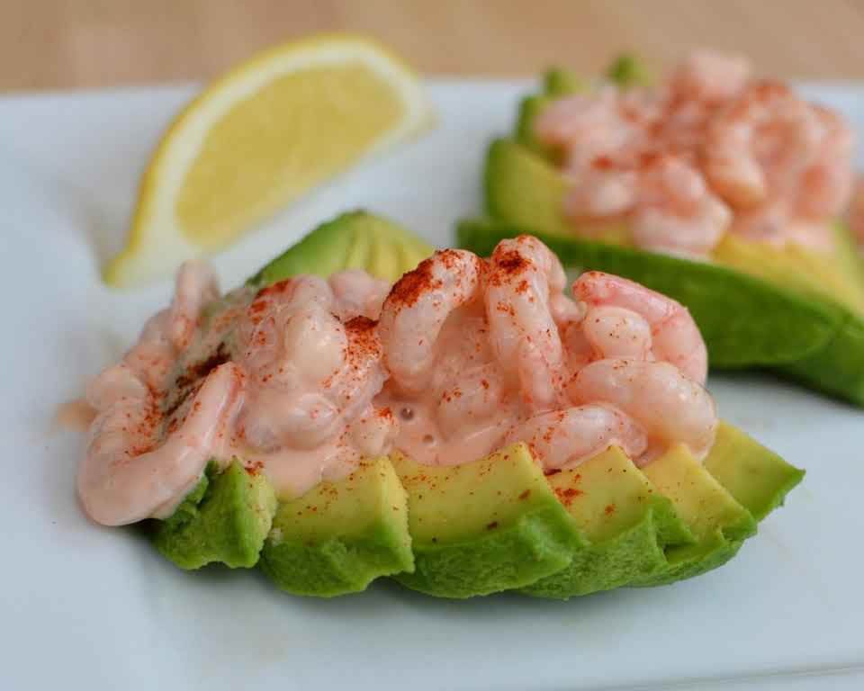 Prawns in a seafood sauce on sliced avocado